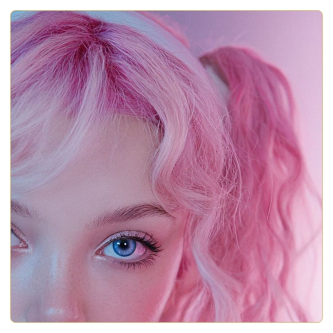Curvy blue eyed pink hair close-up