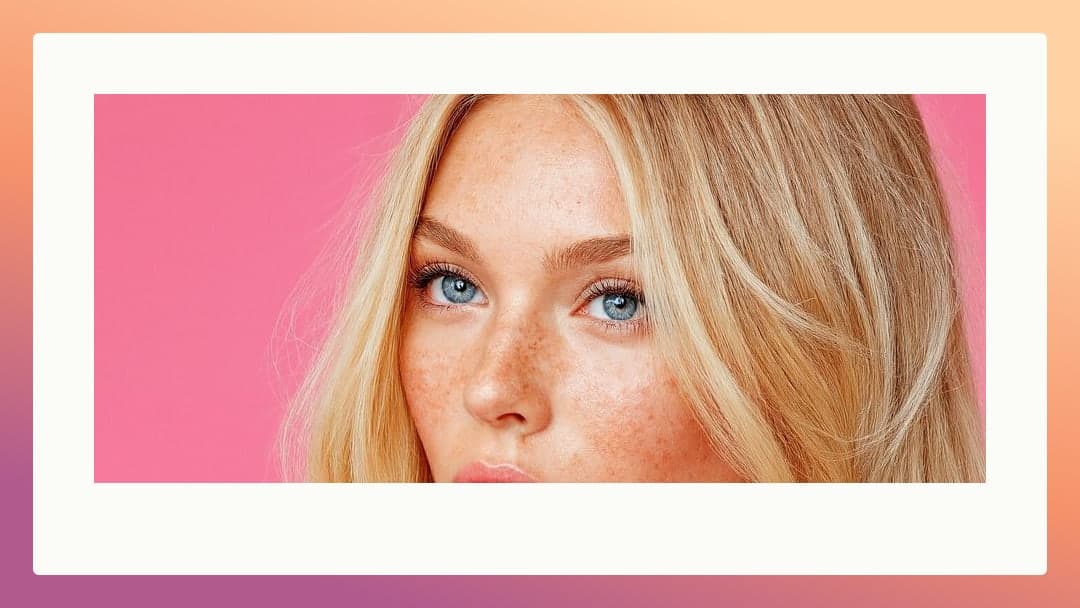 Blonde freckles closeup pink backdrop