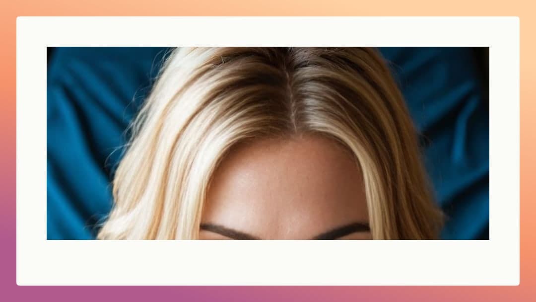 Blonde hair spread on blue sheets