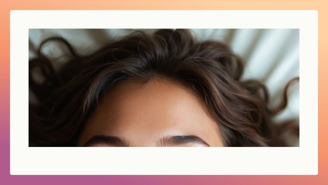 Dark wavy hair on white pillow