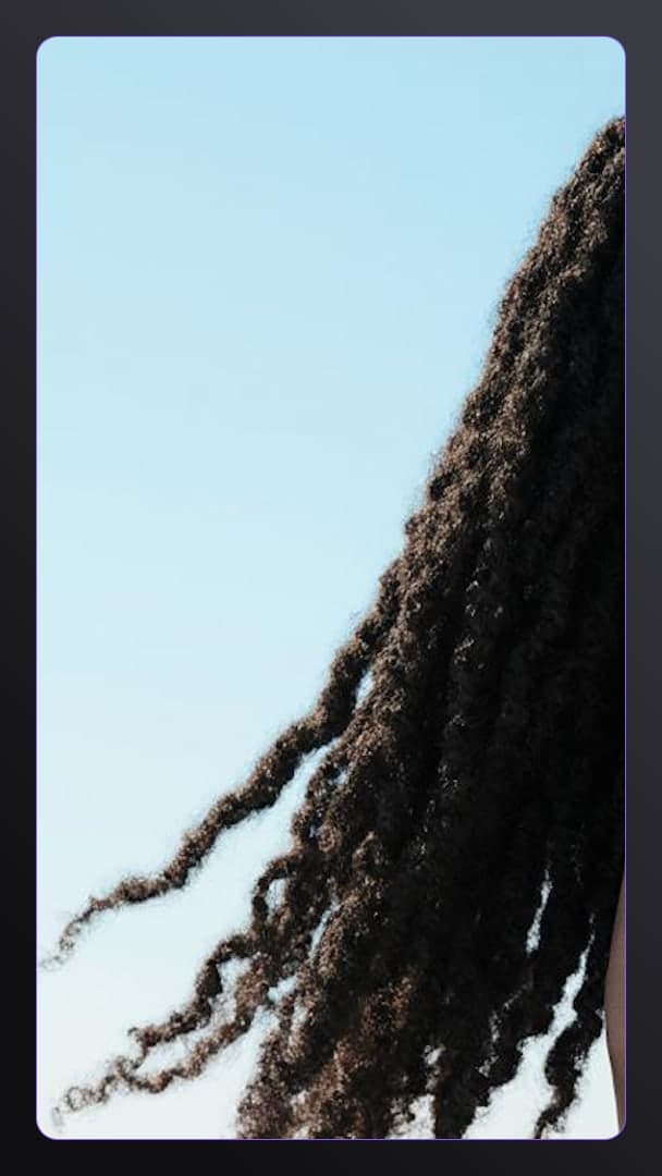 Raven curls against bright blue sky