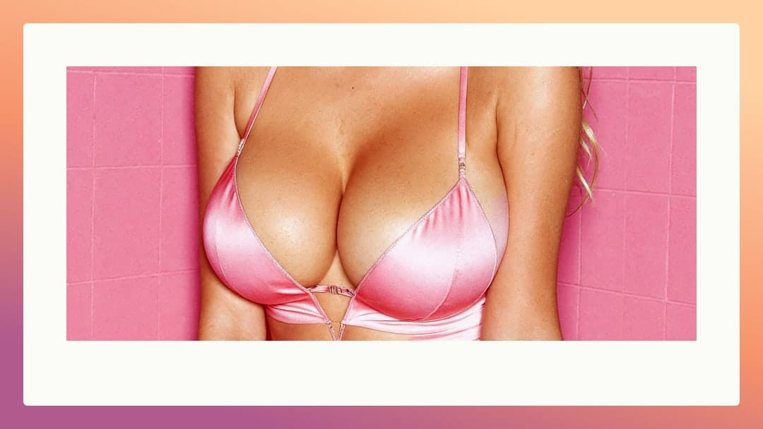 Blonde cleavage in glossy pink satin bra