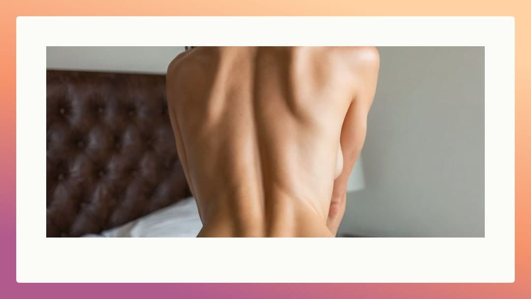 Nude back view on white sheets