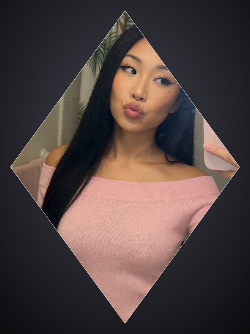 Asian in pink sweater bathroom mirror