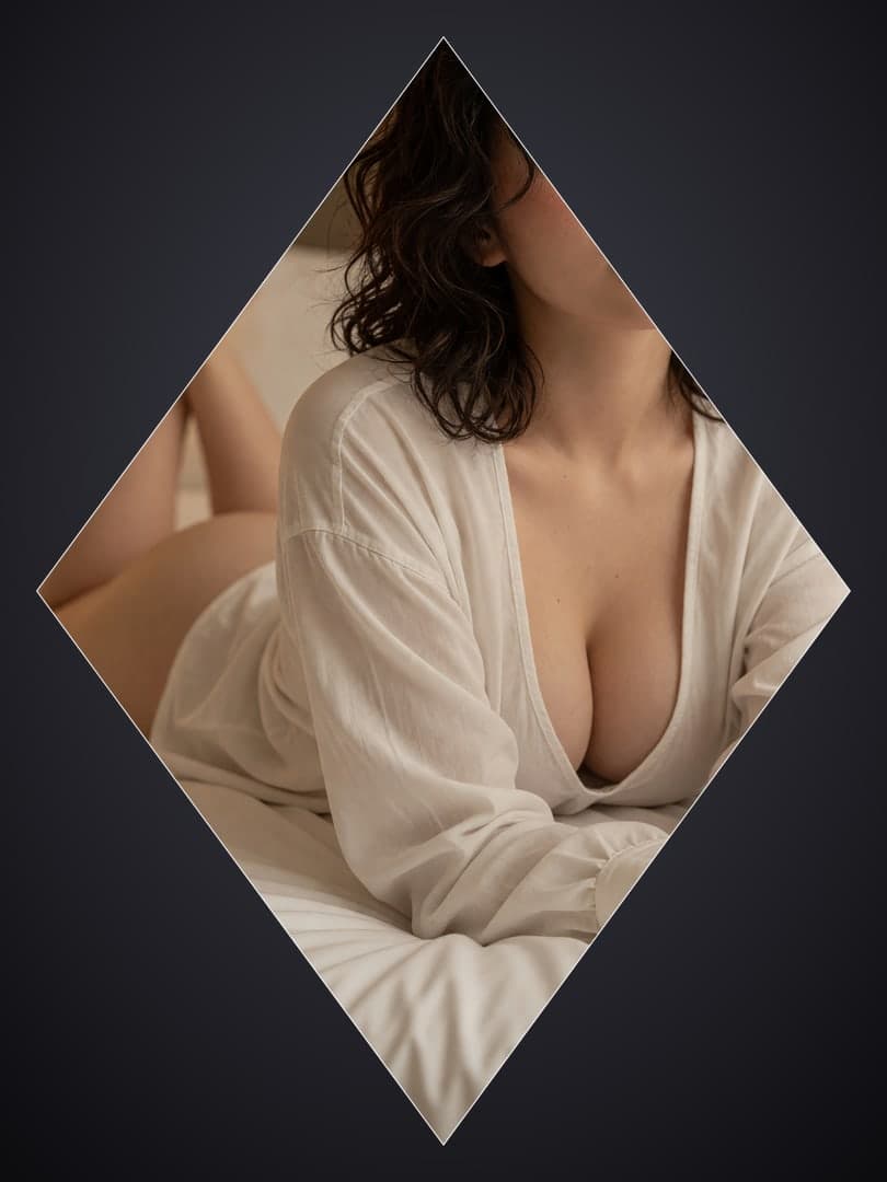Open white shirt on white sheets