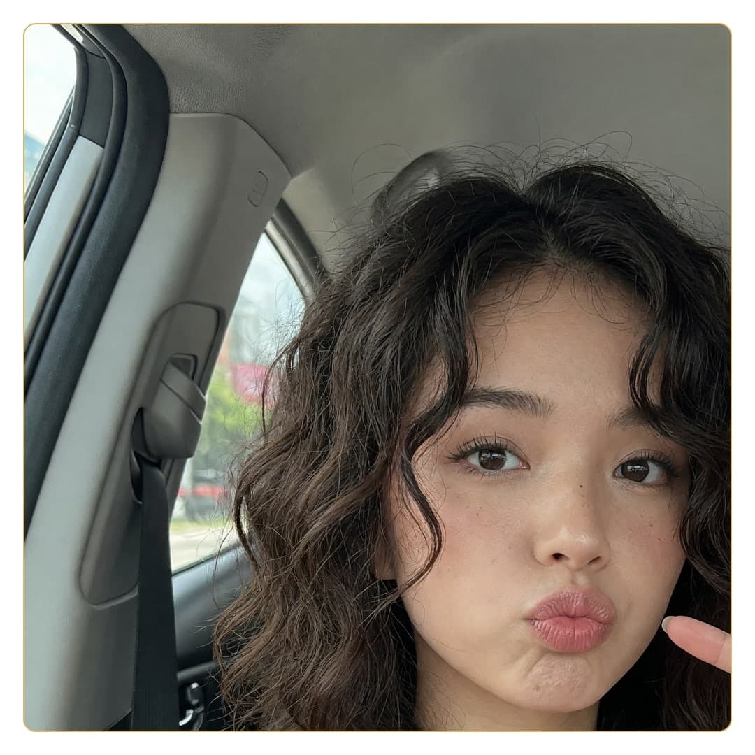 Wavy brunette car selfie pout