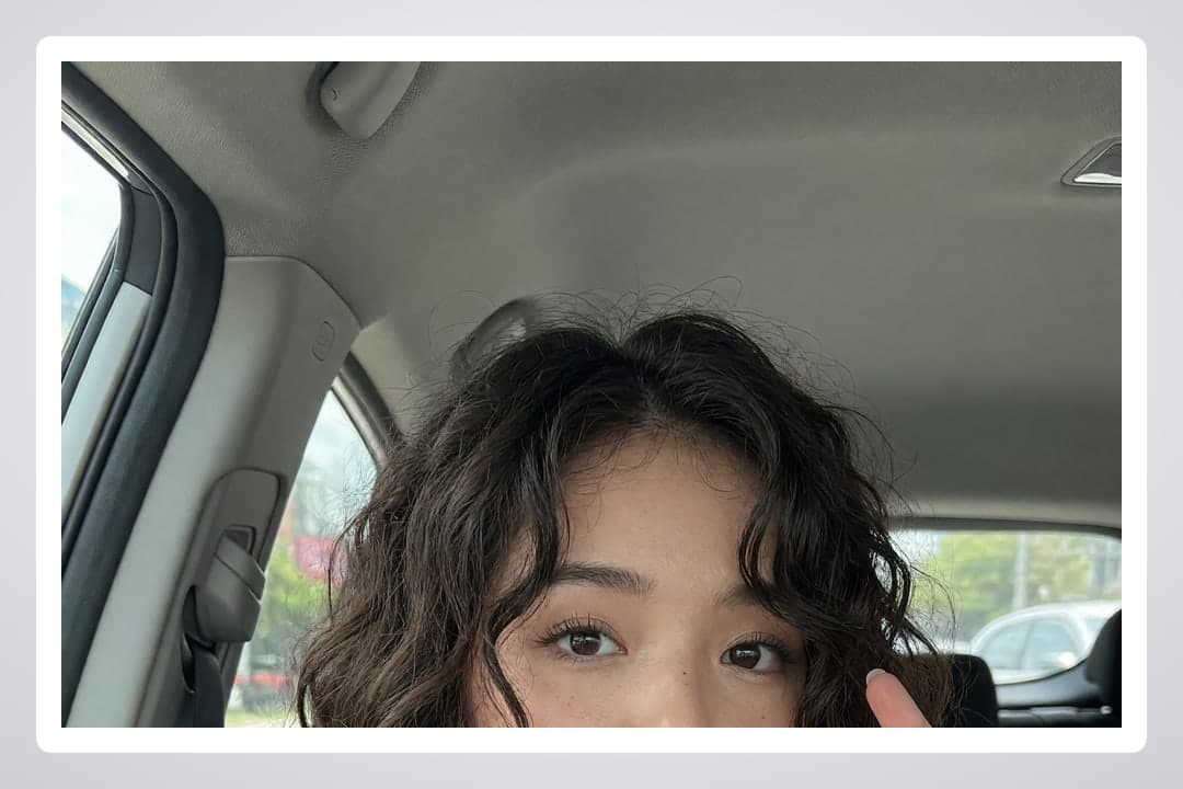 Wavy brunette car selfie daylight