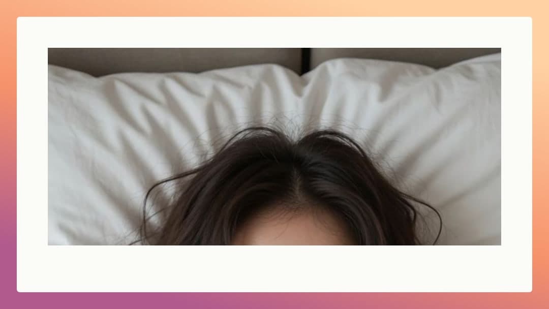 Brunette hair spread across bed