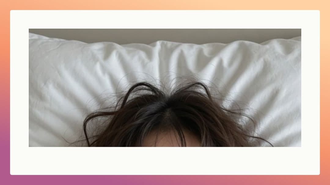Messy brunette hair on white sheets