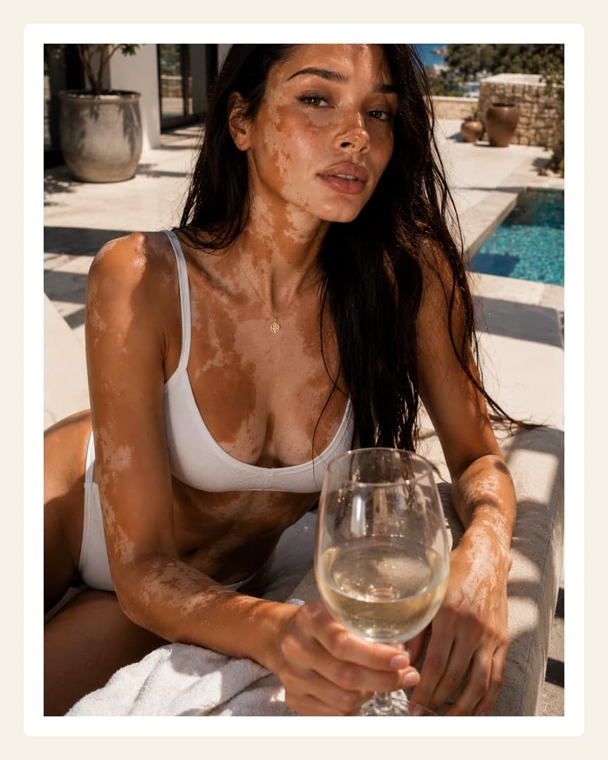 Brunette sips wine poolside in bikini