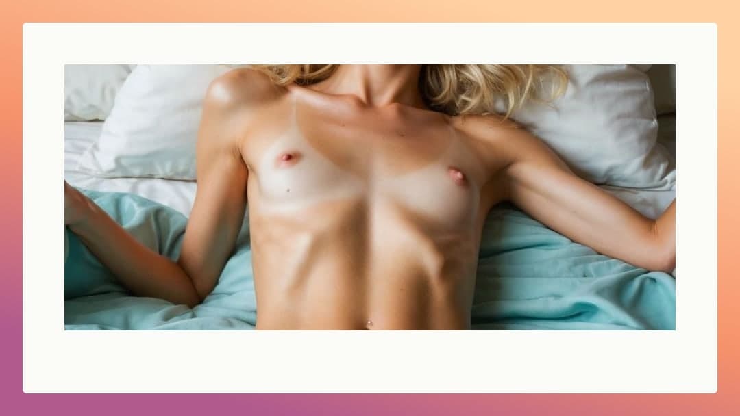 Topless on light blue sheets