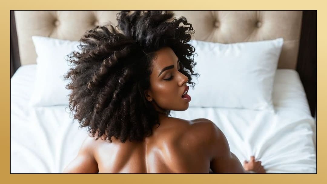 Topless ebony looks back in bed