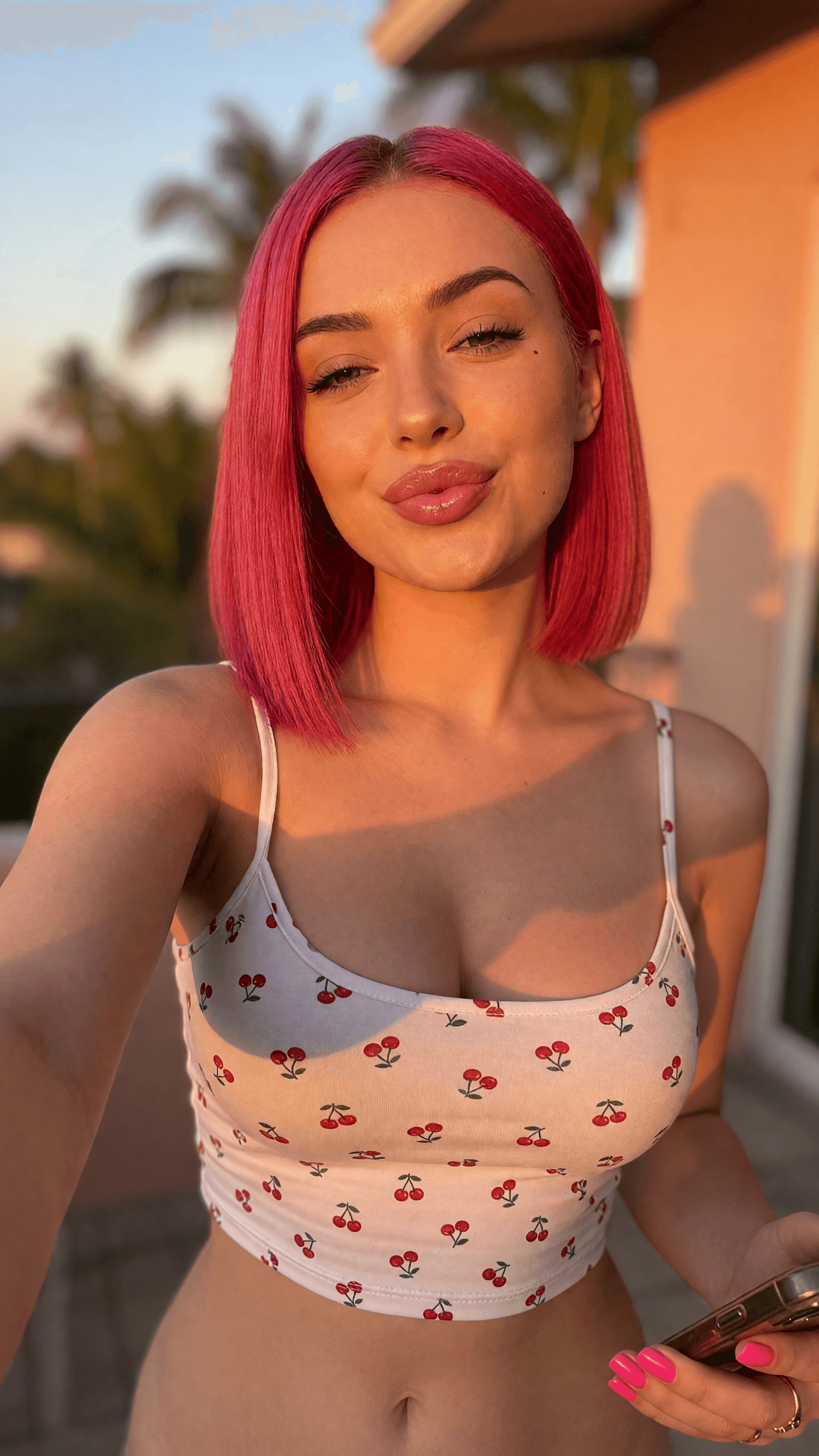 Pink hair cleavage selfie at sunset