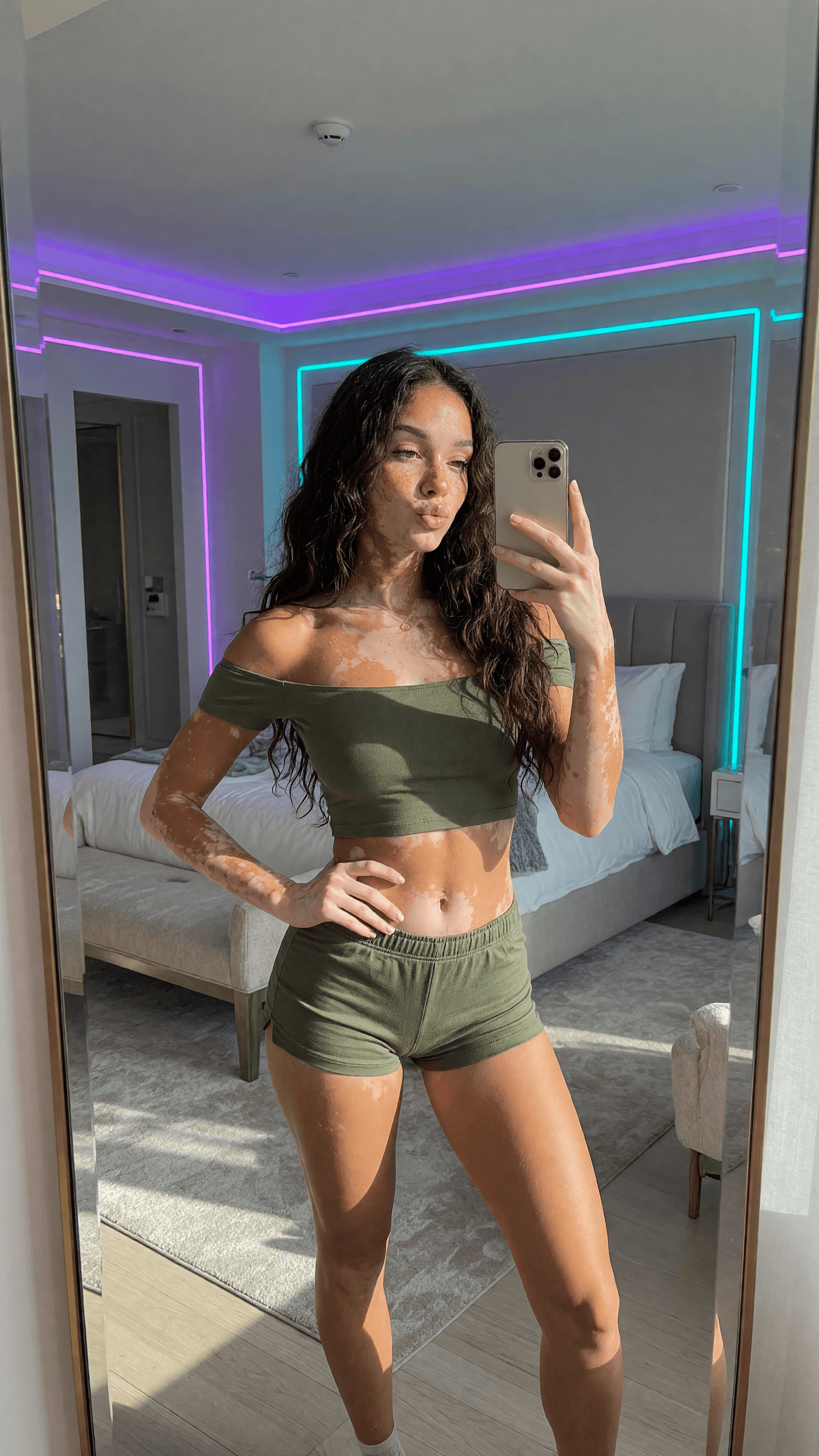 Luxury bedroom mirror selfie in olive crop top and shorts