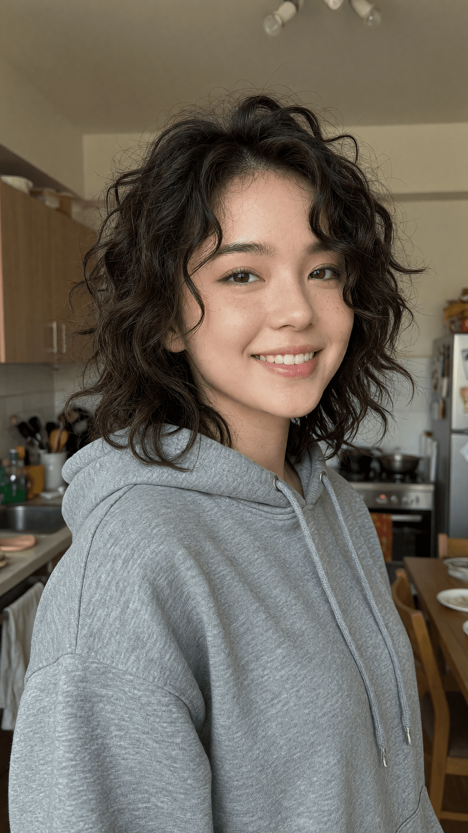 Slim Asian body in oversized hoodie kitchen snap