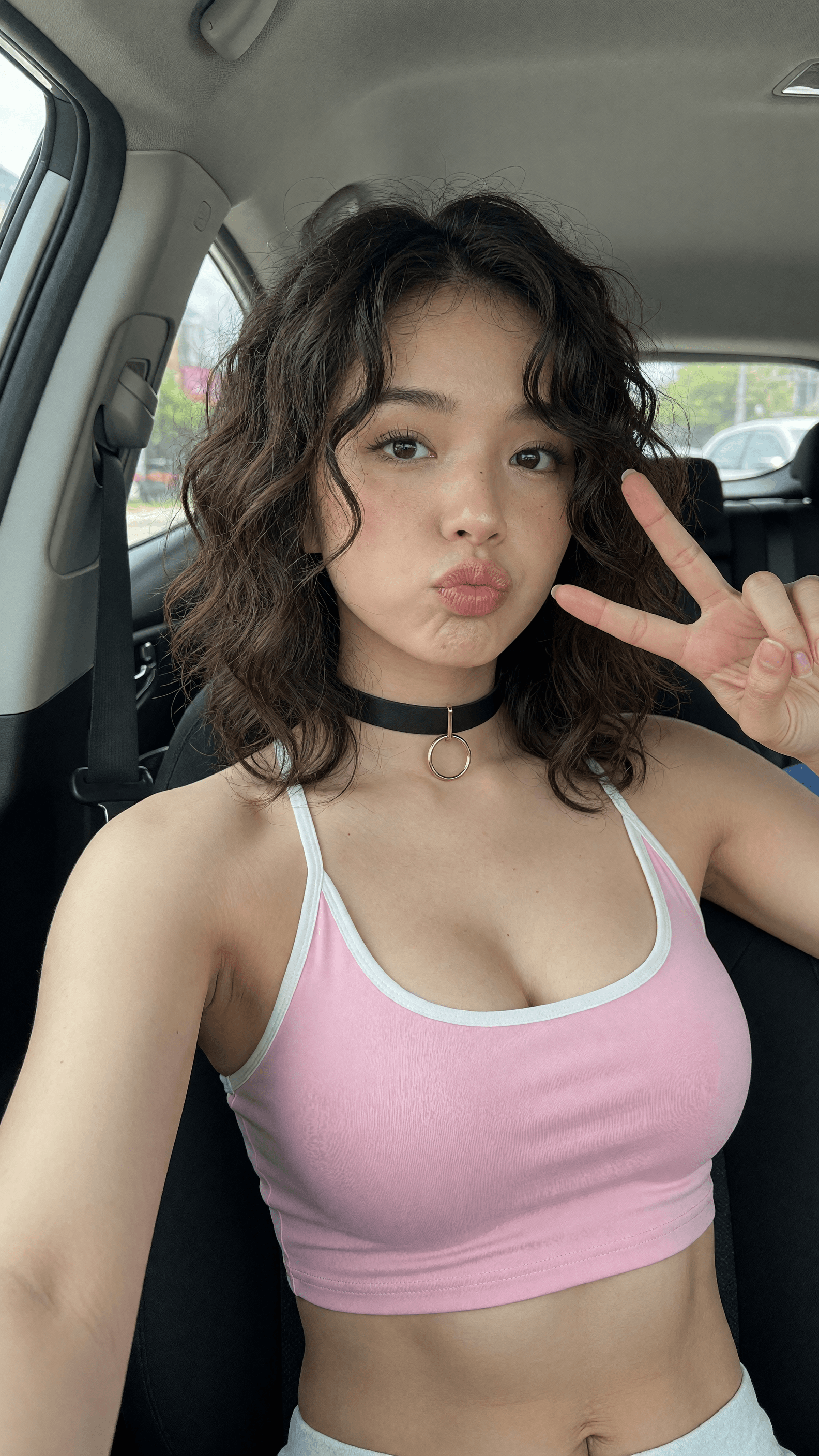 Young adult Asian crop top selfie in car