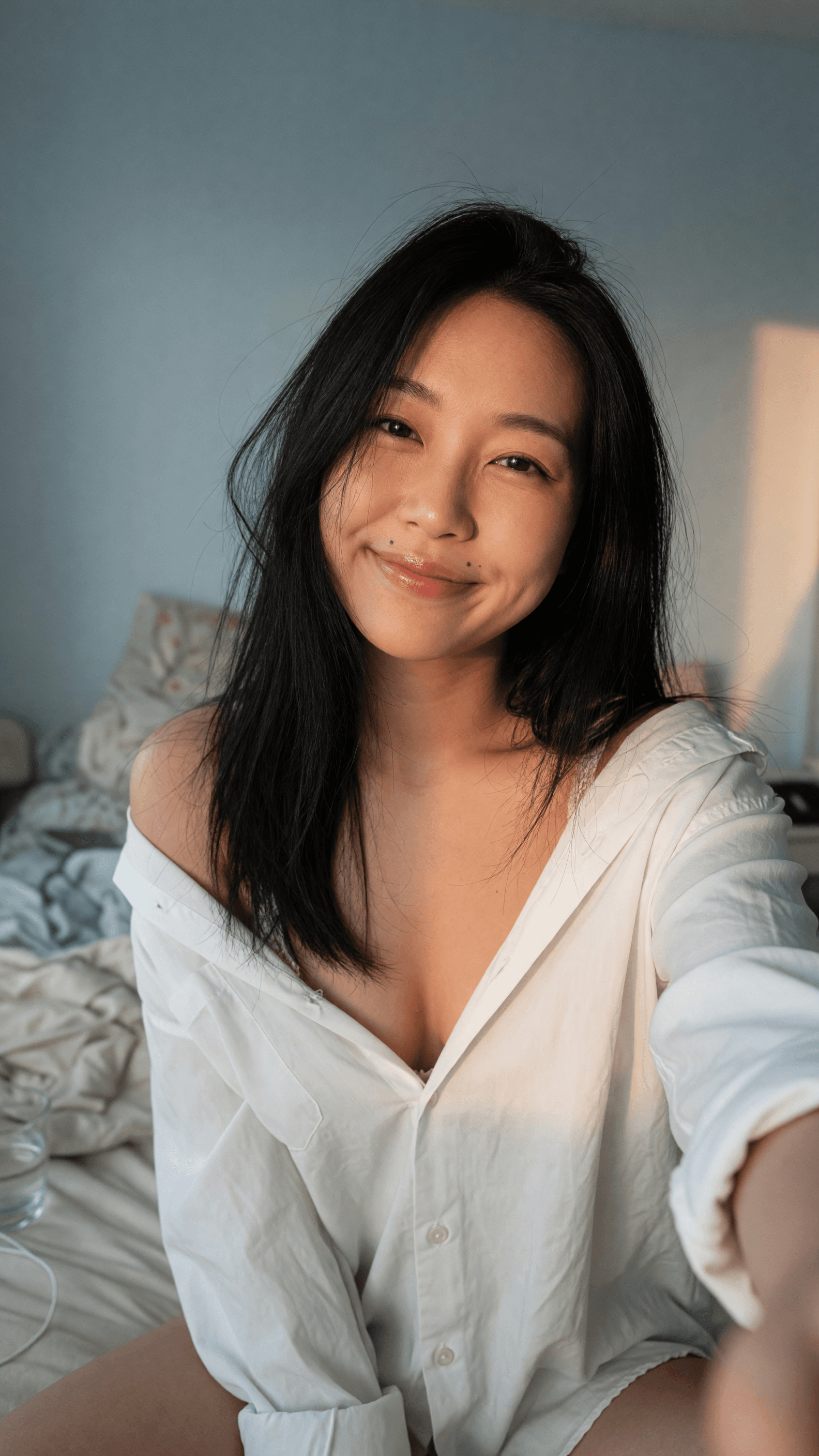 Asian selfie in unbuttoned shirt