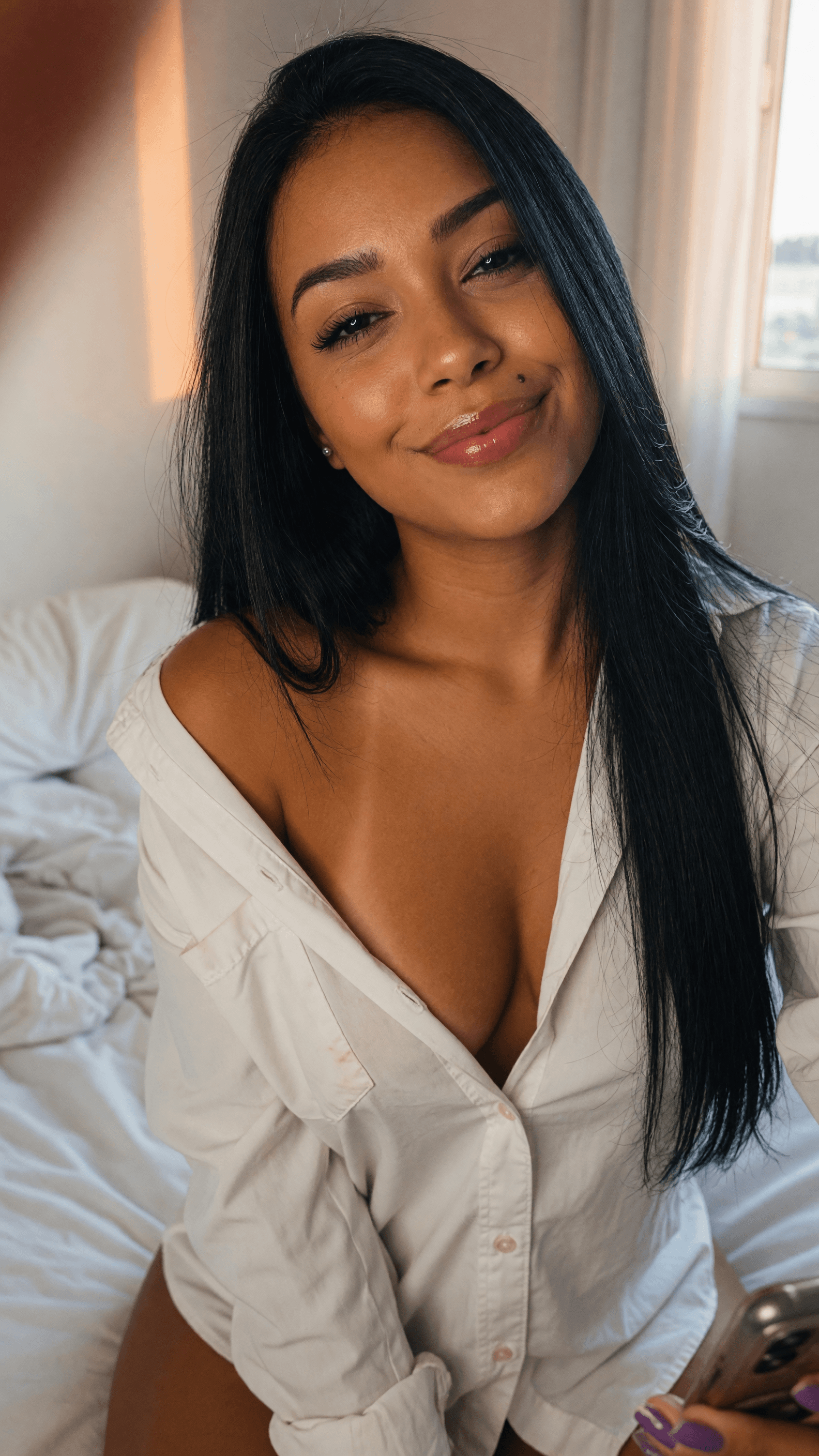 Curvy latina in open shirt on bed