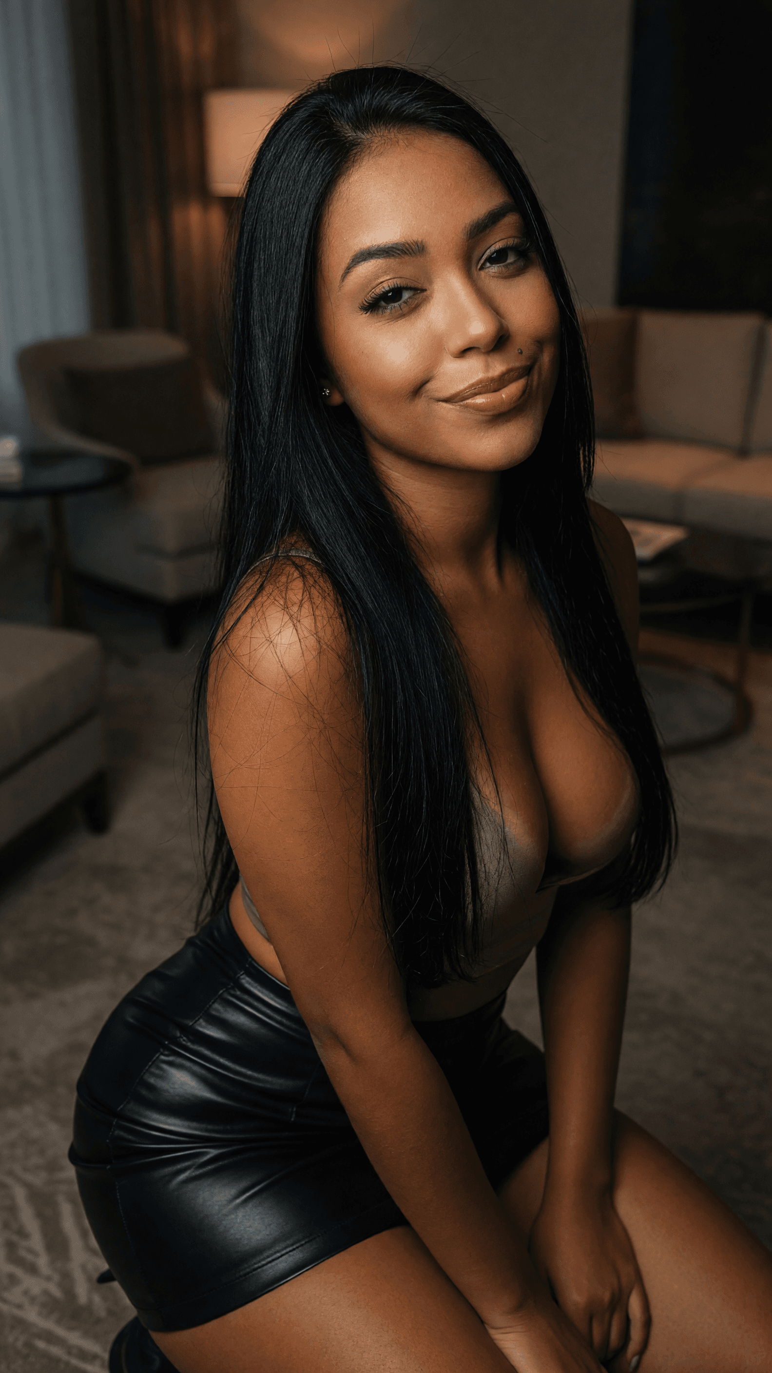 Curvy Latina leans forward in lounge