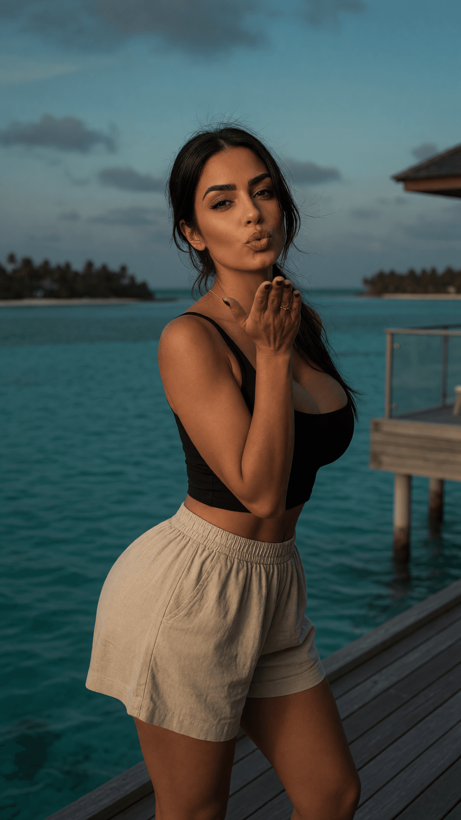 Brunette blowing kiss at dusk
