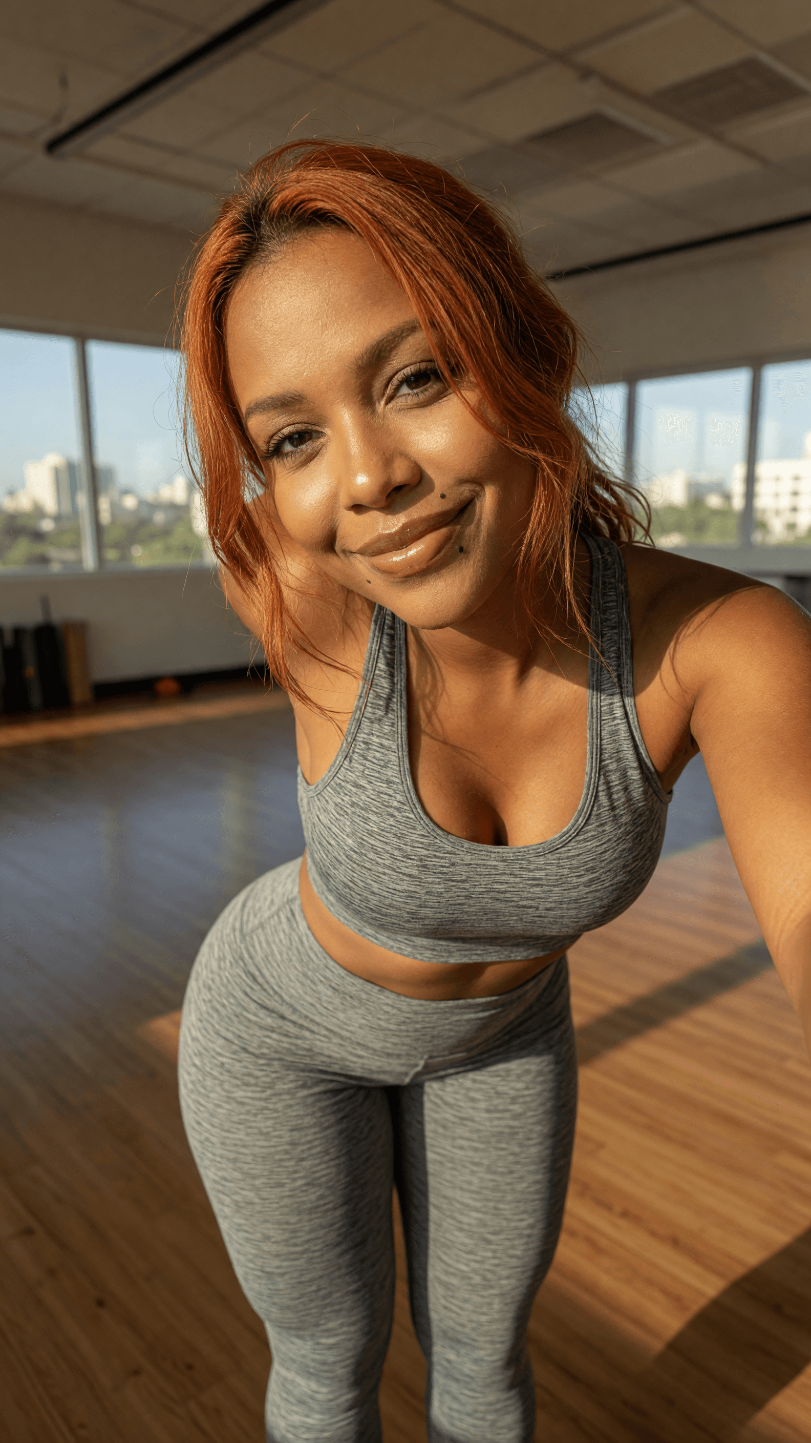Curvy redhead gym selfie in studio