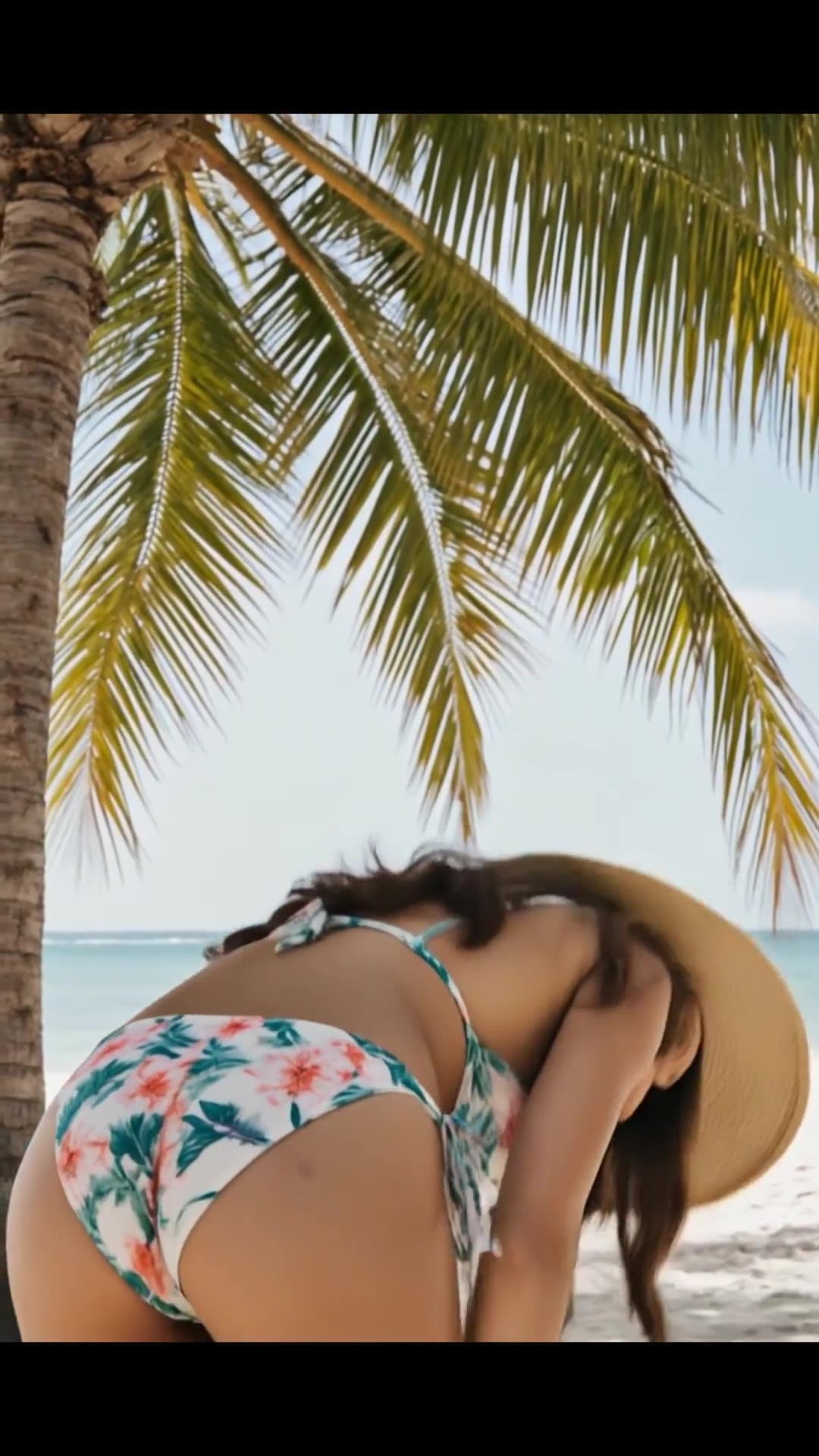 Young Asian curvy brunette in floral bikini beach view