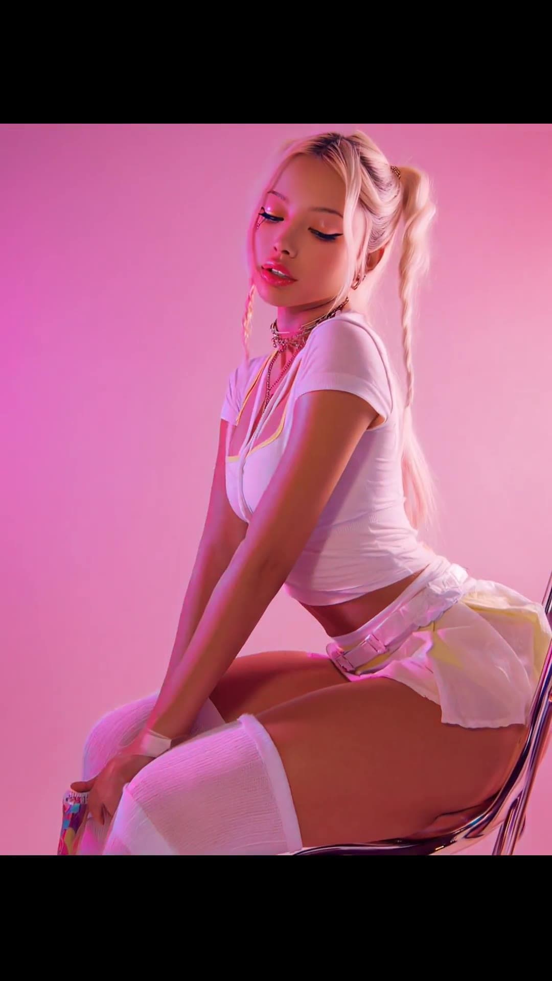 Athletic slim body in white crop top and short skirt