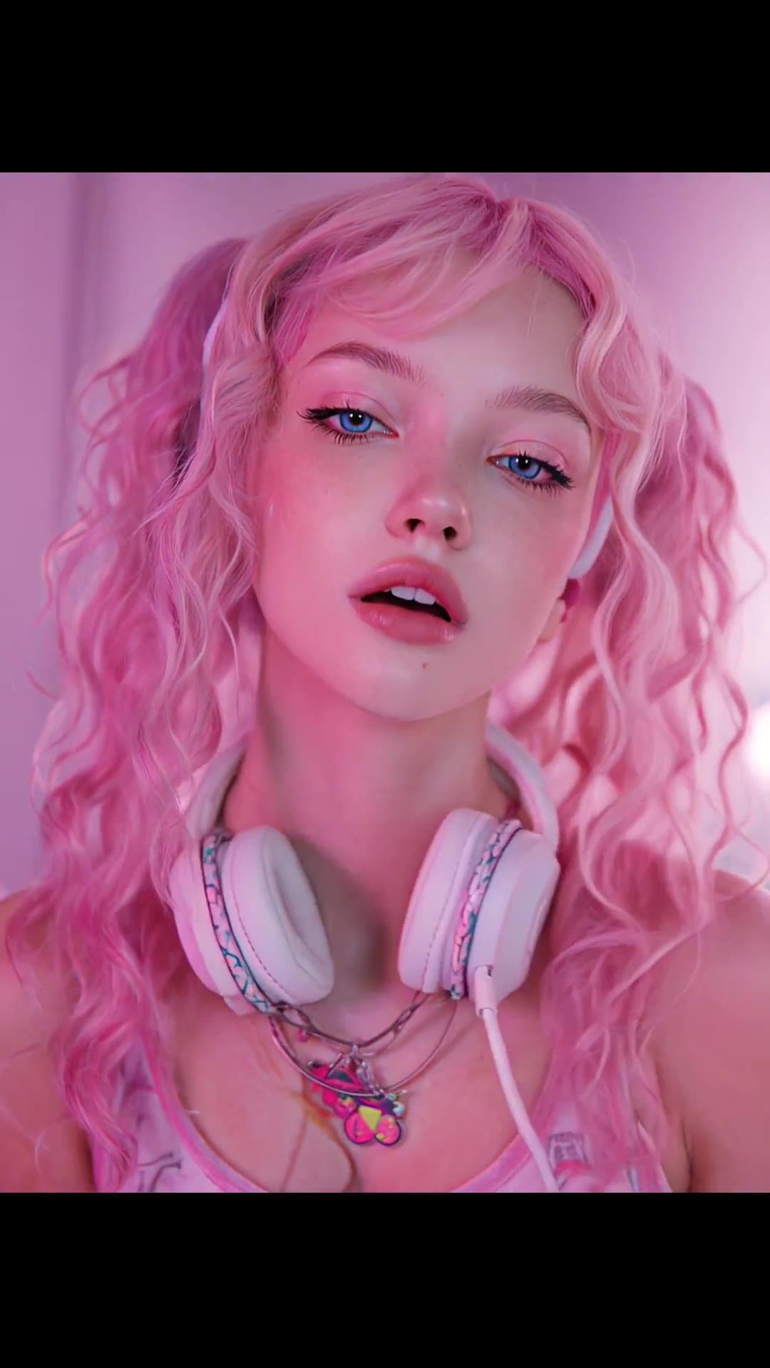 Pink pigtails blue eyes in bedroom close up