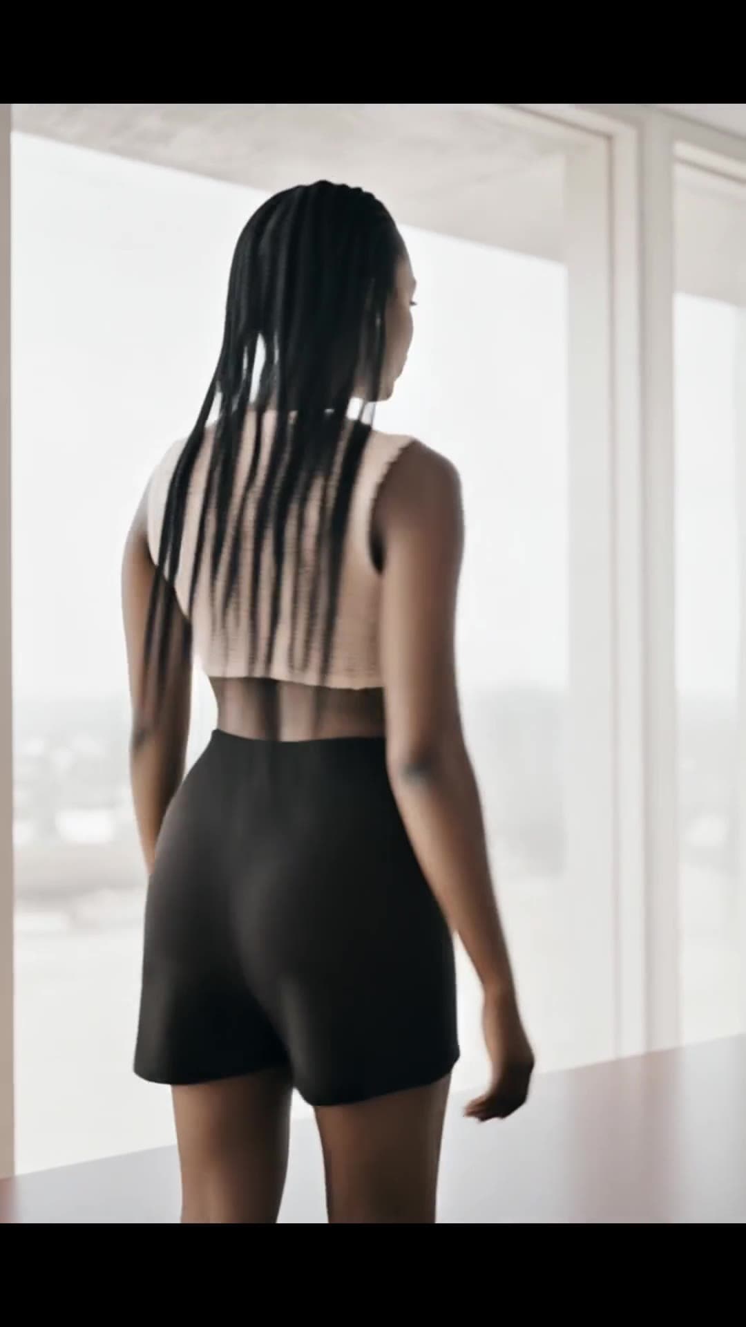 Athletic brunette from behind in crop top and shorts