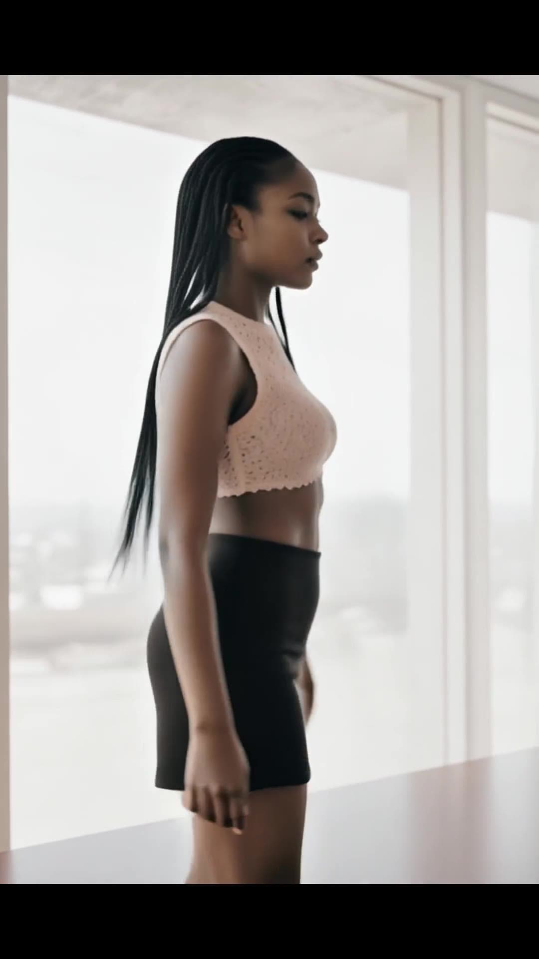 Sheer pink lace crop top by window