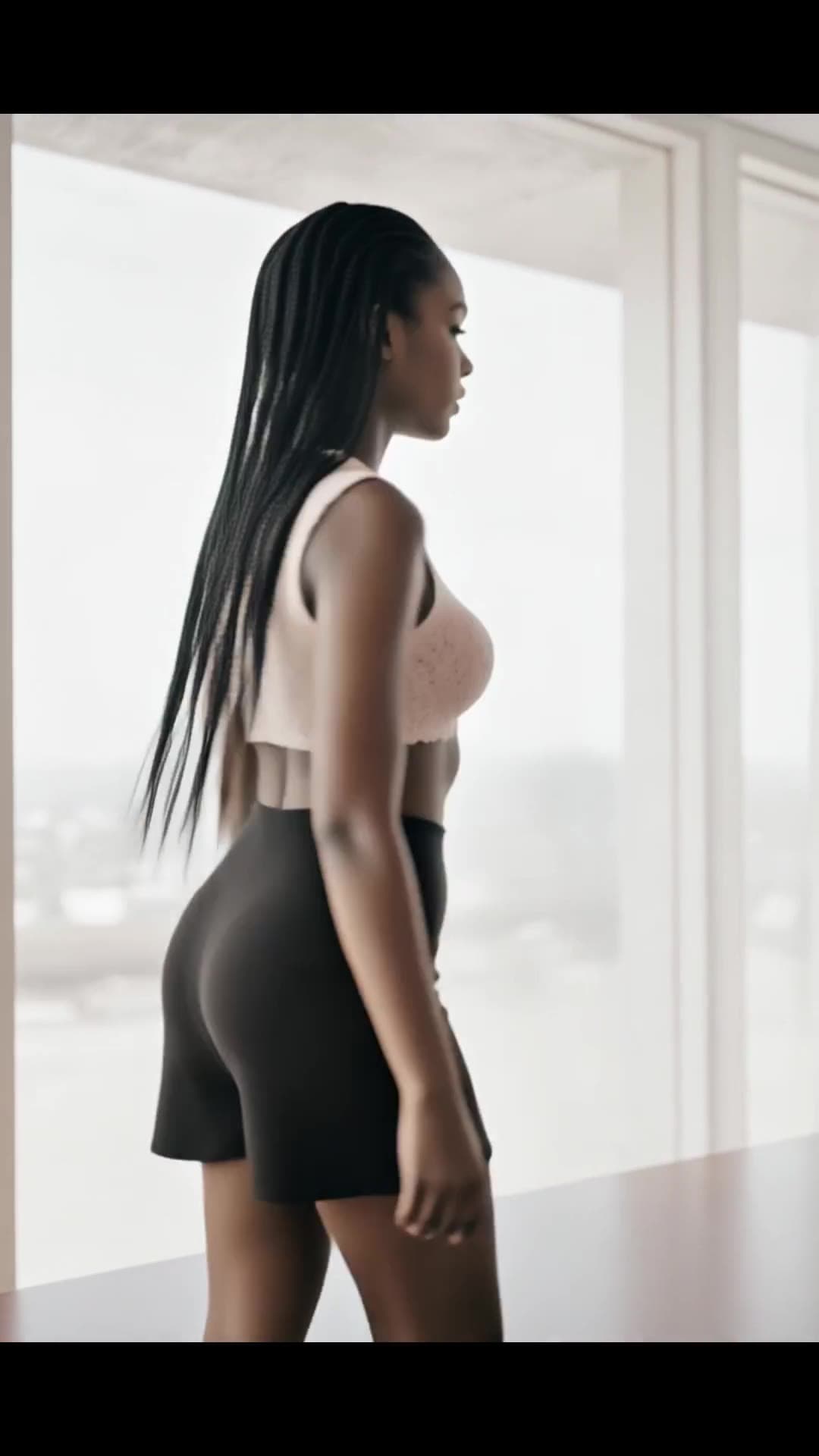Slim Asian at window in pink lace