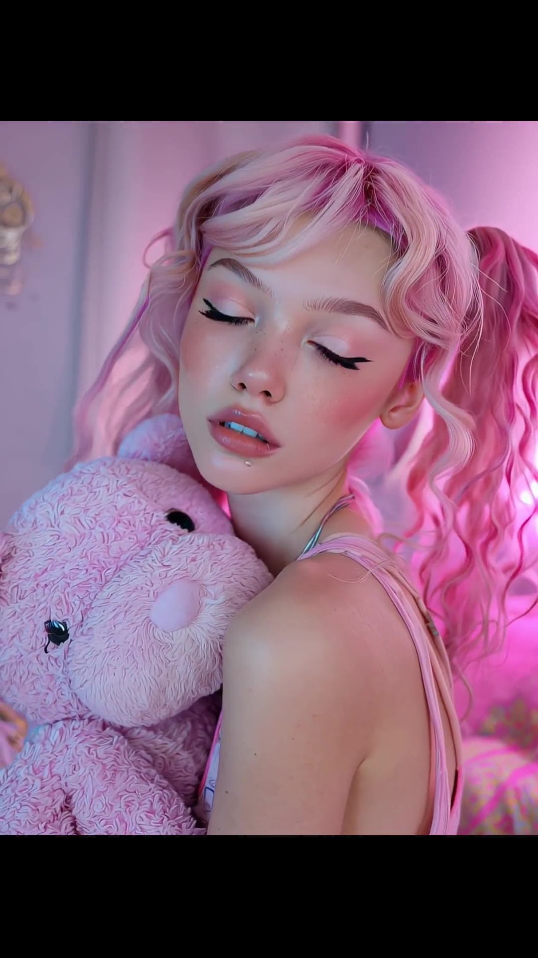 Young adult with pink teddy bear