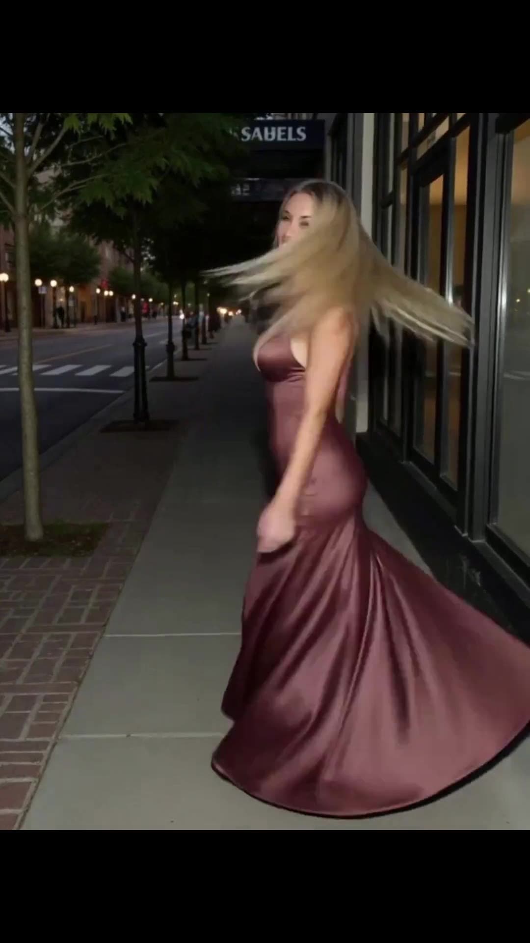 Burgundy satin gown on city sidewalk