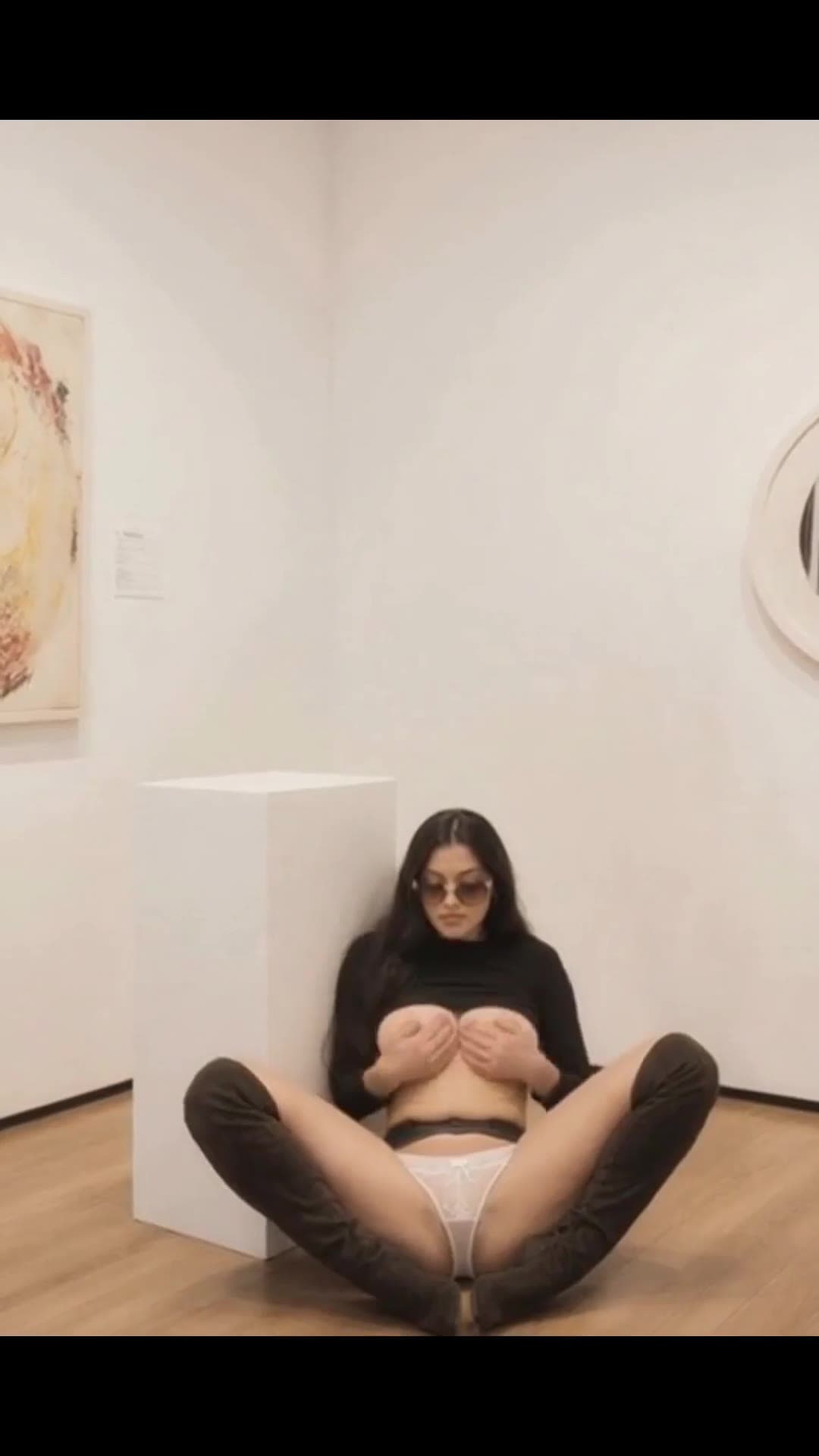 Young adult topless in art gallery