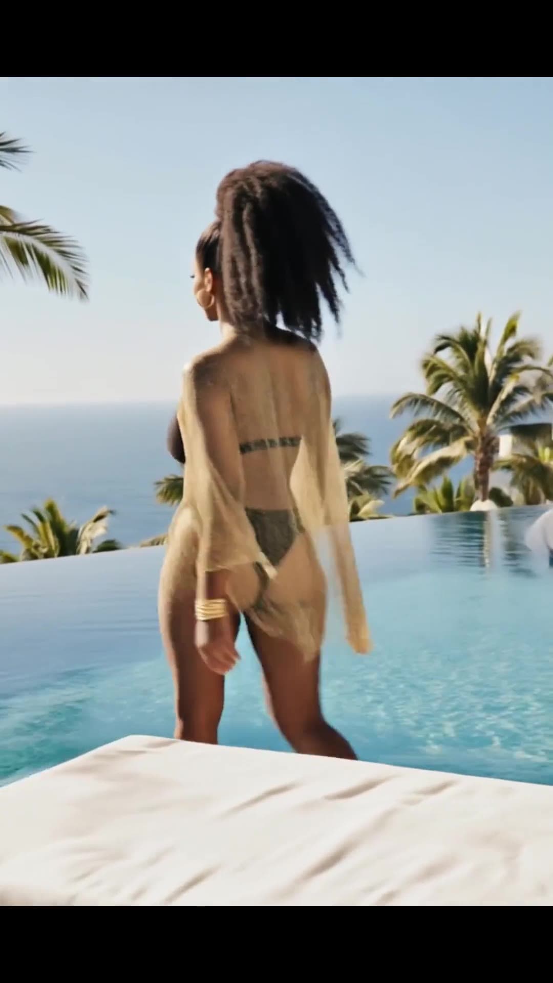 Curvy raven hair poolside from behind