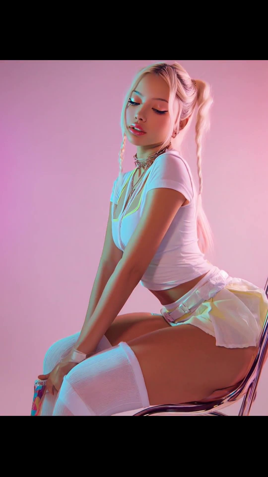Curvy blonde in pigtails on acrylic chair