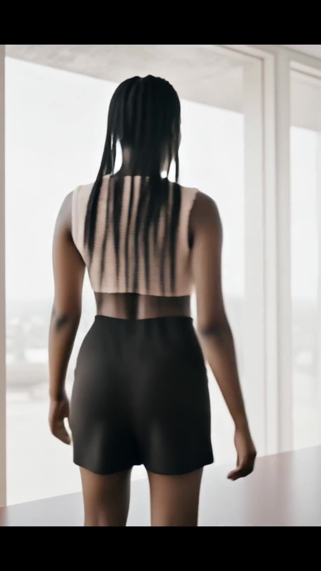 From behind in tight black shorts