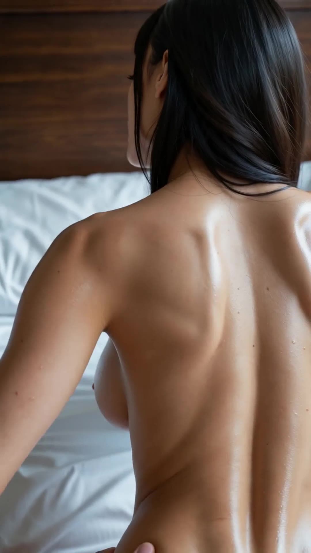 Young adult topless from behind on bed