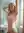Young adult pink hair bathroom stretch