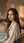 Young brunette bedroom over-the-shoulder glance