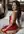 Red satin dress over shoulder glance