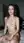 Nude brunette kneels on mattress