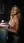 Nude blonde leans on washer