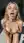 Curvy blonde on knees tongue out