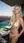 Blonde in white bikini on rooftop