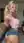Living room selfie blonde in pink crop top and denim shorts