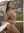 Curvy nude balcony over-shoulder glance
