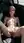Nude brunette reclines in car