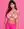 Pink lace bra against studio backdrop