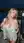 Blonde pulls romper down on rooftop